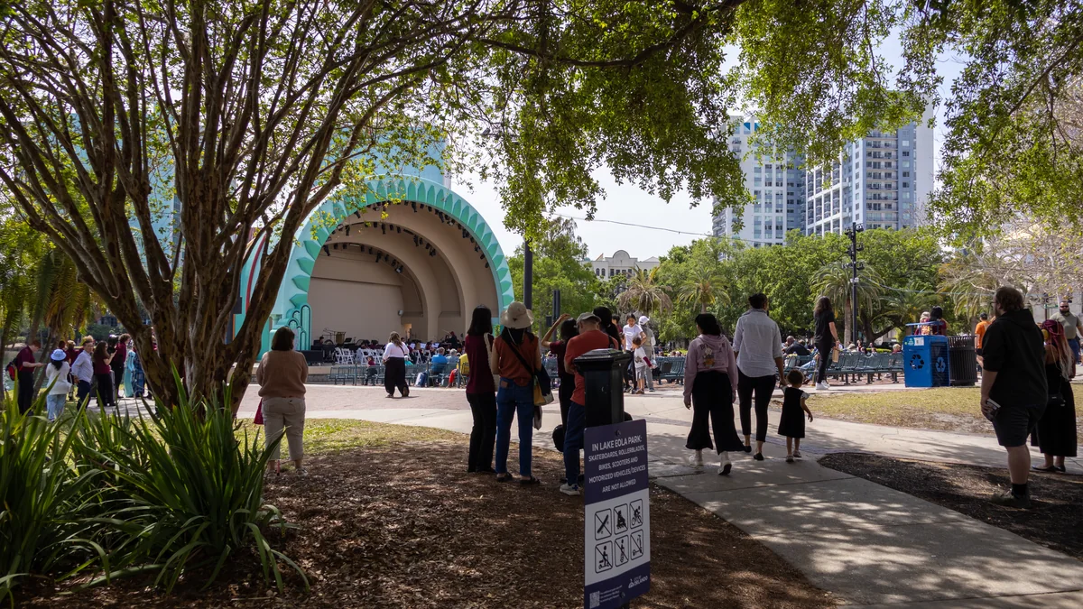 Families gathering near the Walt Disney Amphitheater at Lake Eola Park in Orlando
