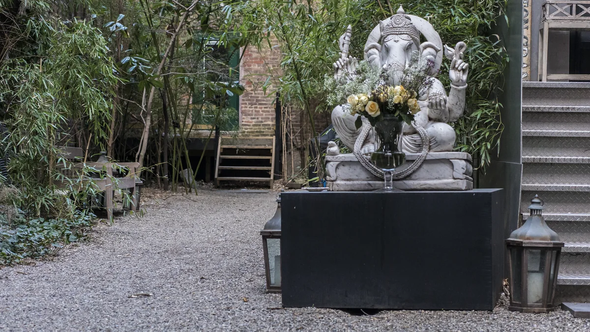 A quiet hidden garden in New York City with greenery and brick walls